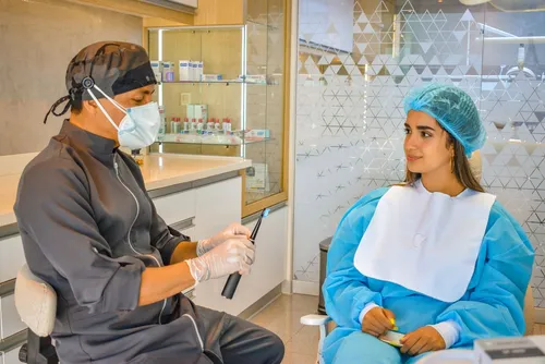 Dentist and patient reviewing a digital treatment plan at a consultation desk — the first step of the dental tourism process at Taki Dent Antalya